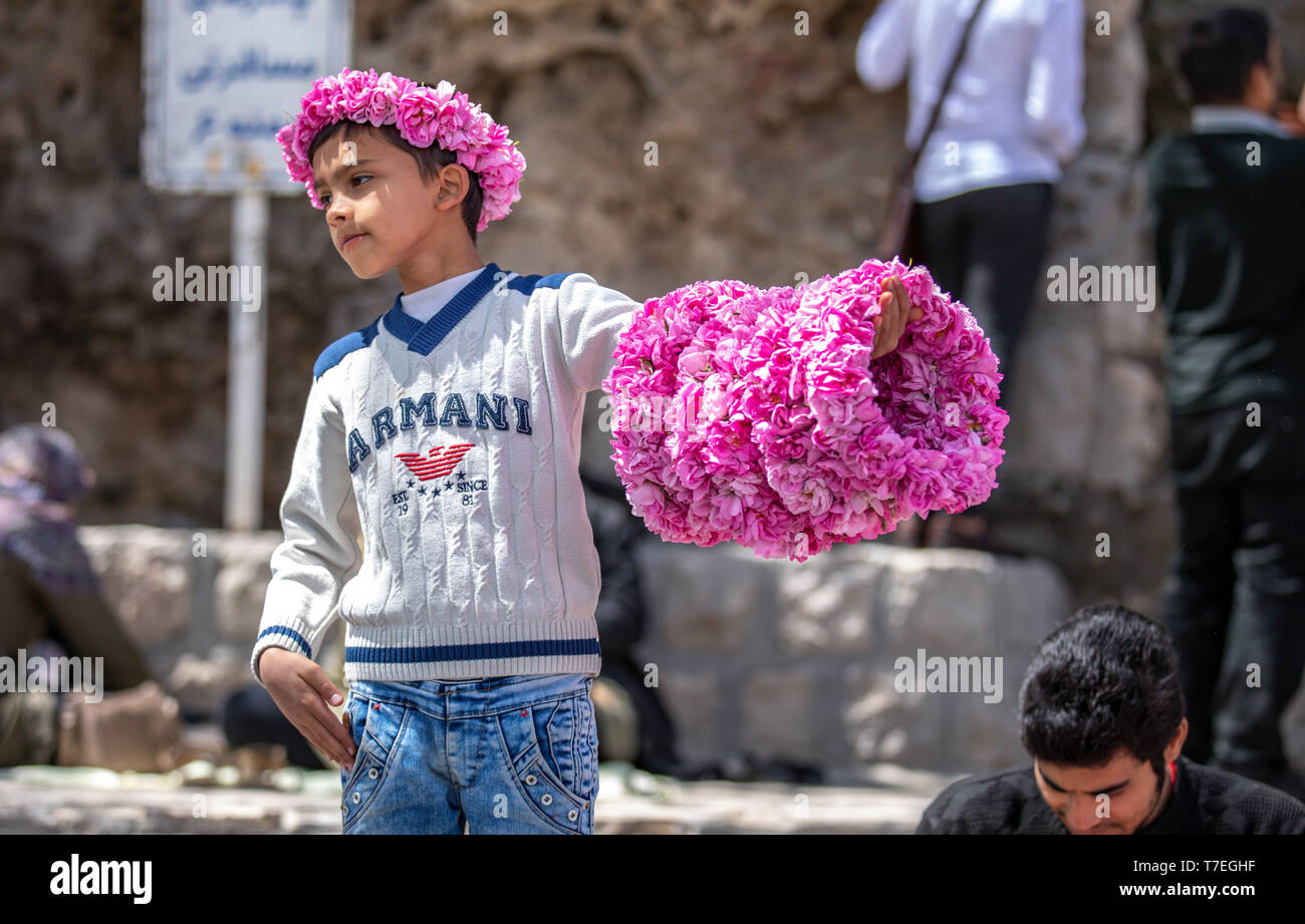 Niasar, Iran, 25th April 2019 iranian young man with flowers, selling