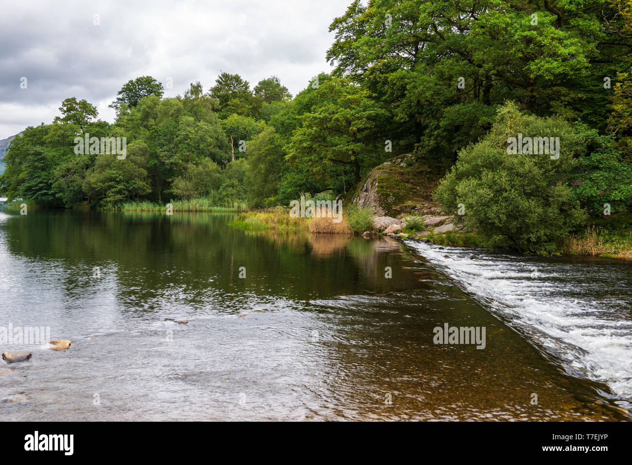 Weir at outlet of Grasmere Lake in the Lake District National Park, Cumbria, England, UK Stock