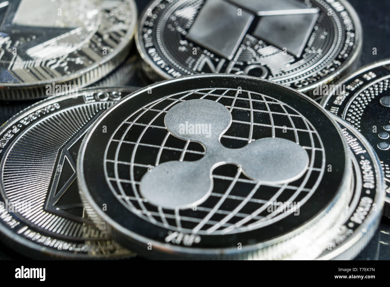 Ripple cryptocurrency physical coin surrounded with variety of other crypto altcoins. Stock Photo