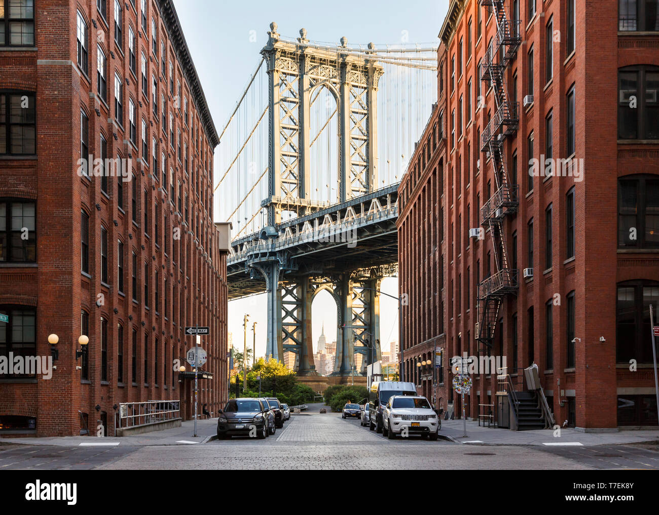Brooklyn, NY historic DUMBO neighborhood street scene with view of Manhattan Bridge and Empire State Builiding Stock Photo