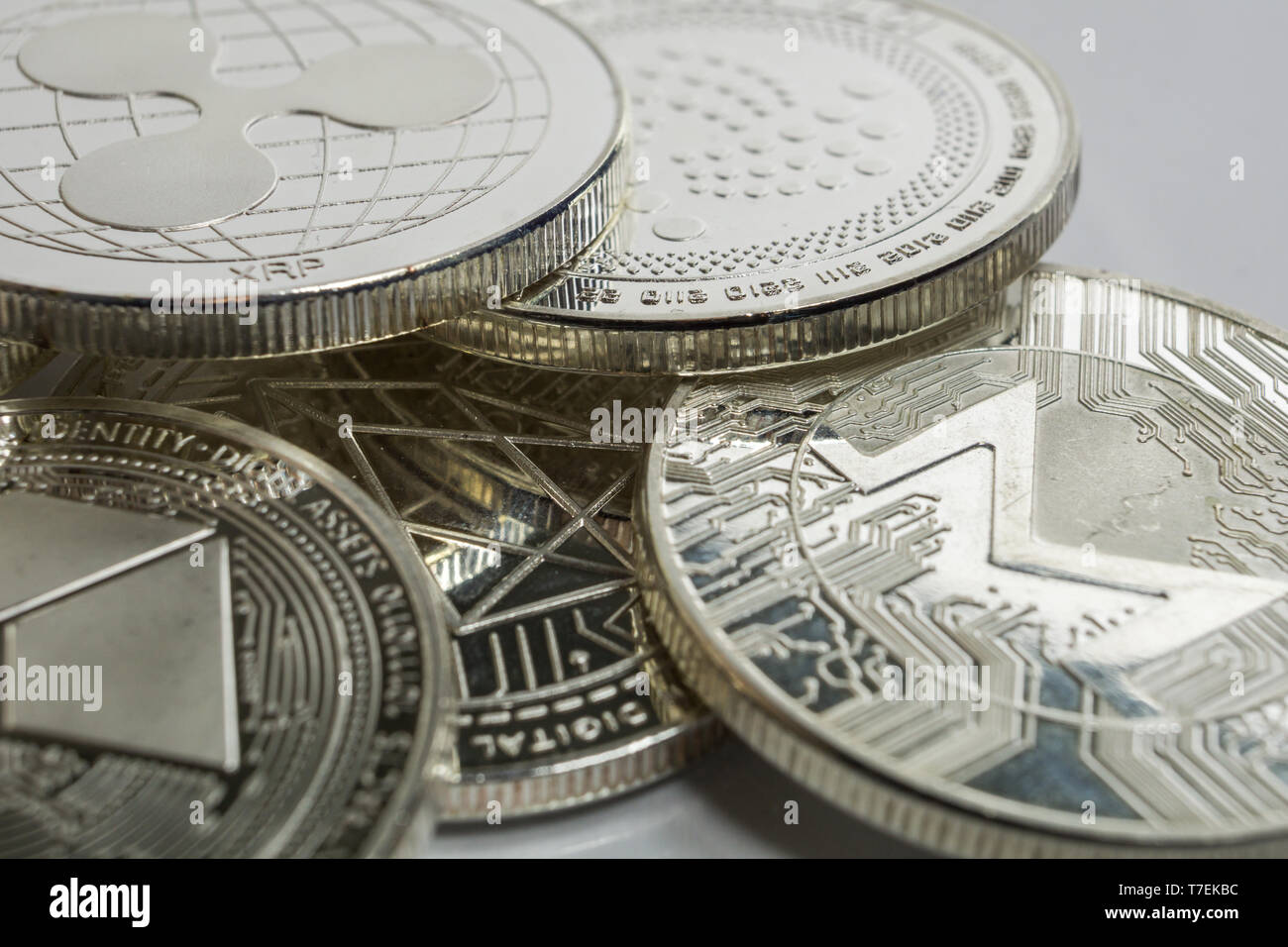 Blockchain cryptocurrency physical coins surrounded with variety of other crypto altcoins. Stock Photo