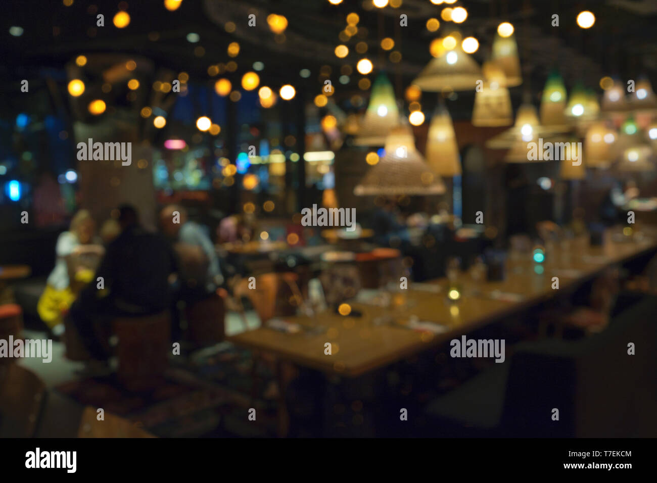 Blurred background of people sitting at restaurant, bar or night club with  colorful lights bokeh. Abstract defocused blur background Stock Photo -  Alamy