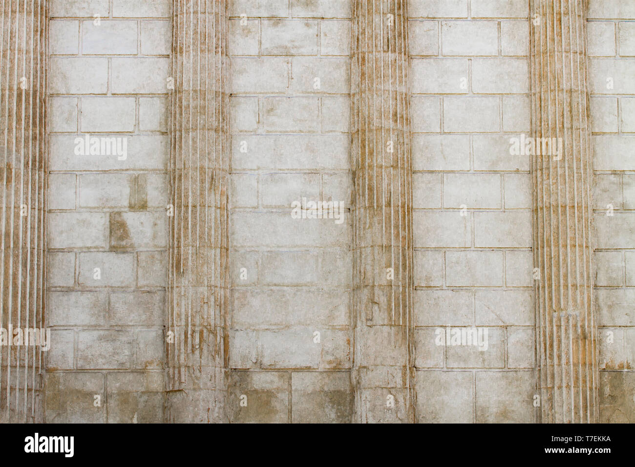 White classical columns and stone wall background Stock Photo - Alamy