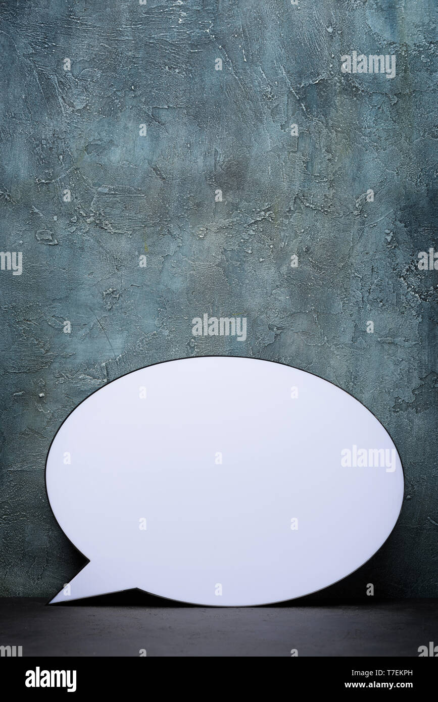 Speech Bubble lightbox on table. Plastic light box in form of chat message icon. Stock Photo