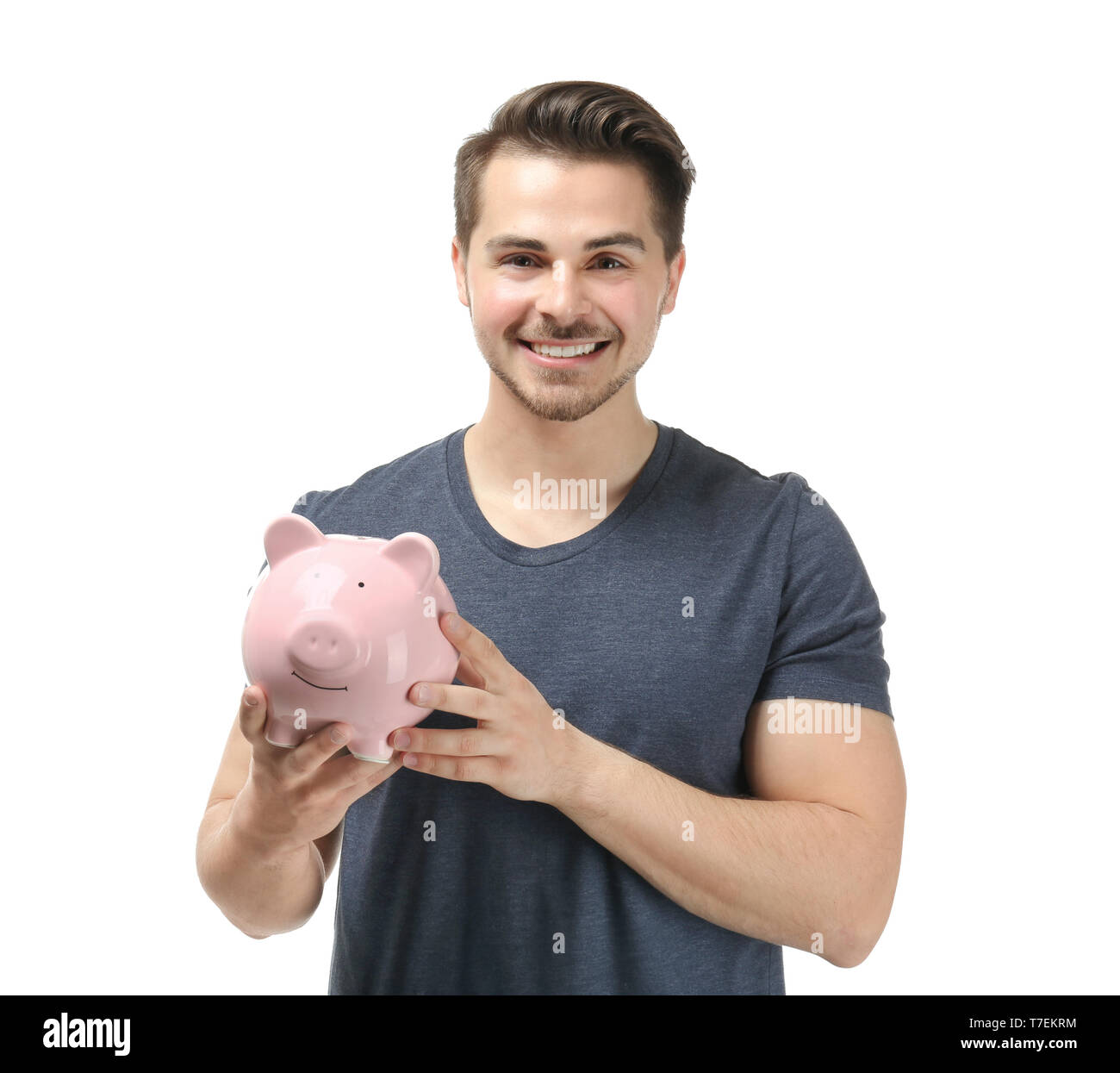 Young man holding piggy bank on white background. Money savings concept ...