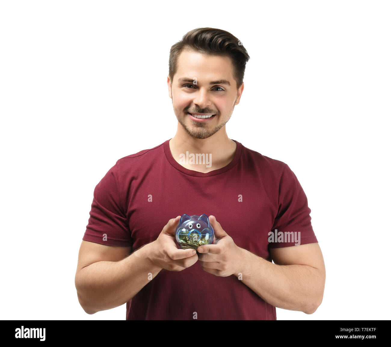 Young man holding piggy bank on white background. Money savings concept ...