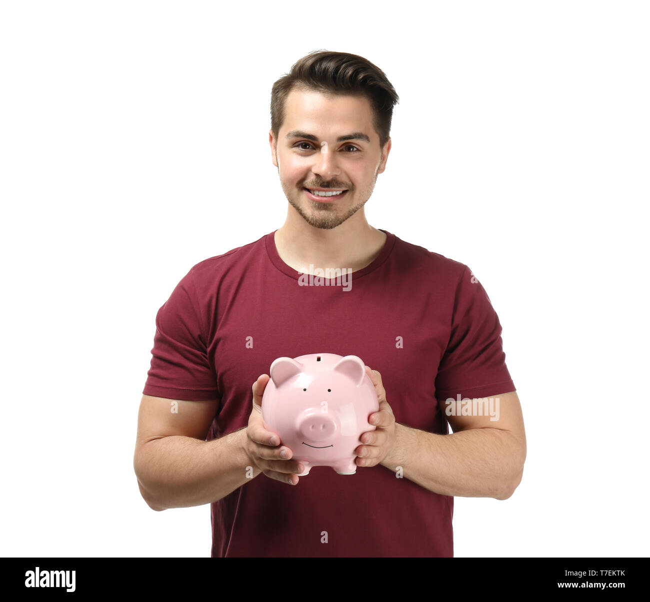 Young man holding piggy bank on white background. Money savings concept ...