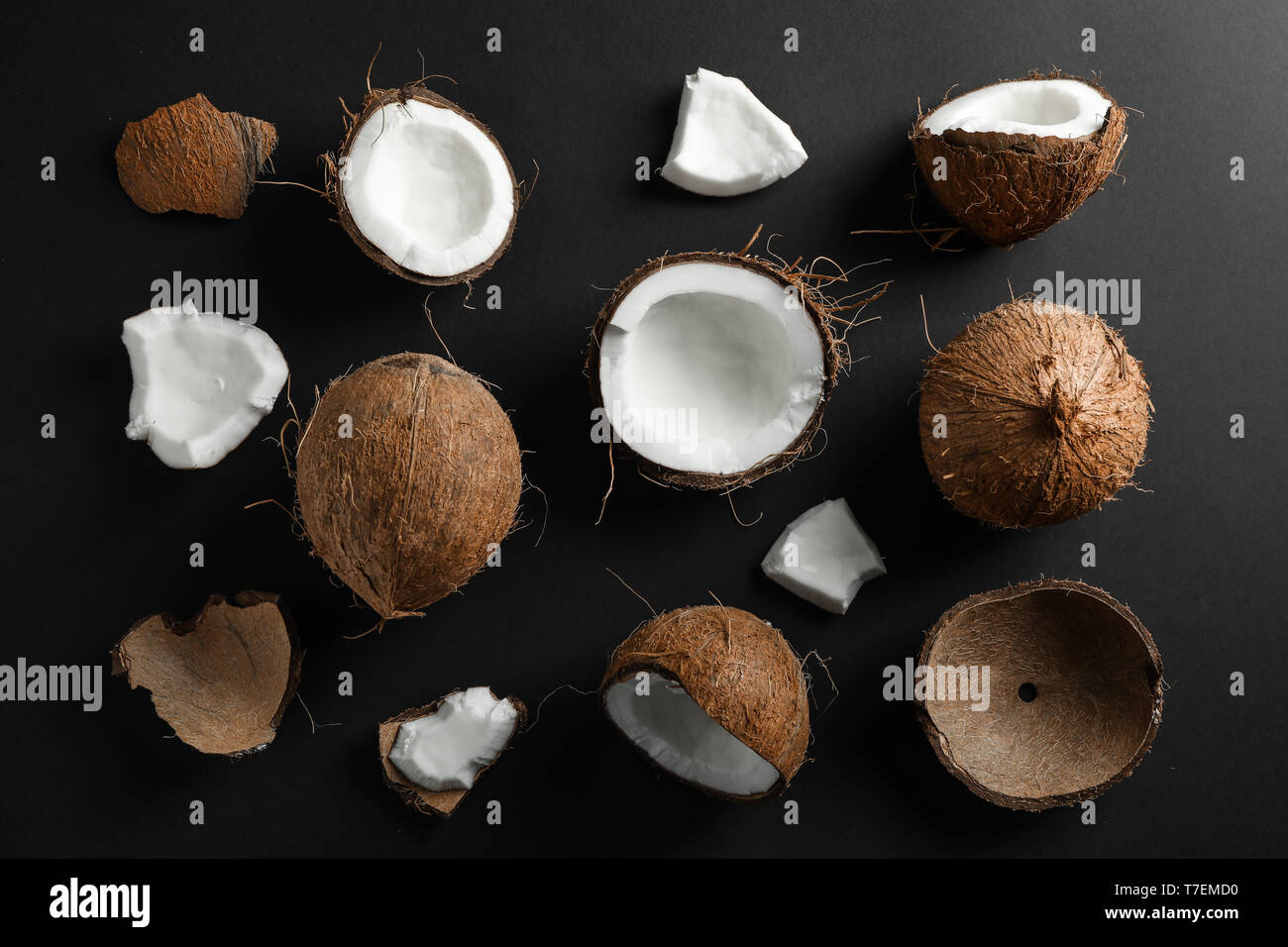 Flat lay composition with coconuts on black background Stock Photo