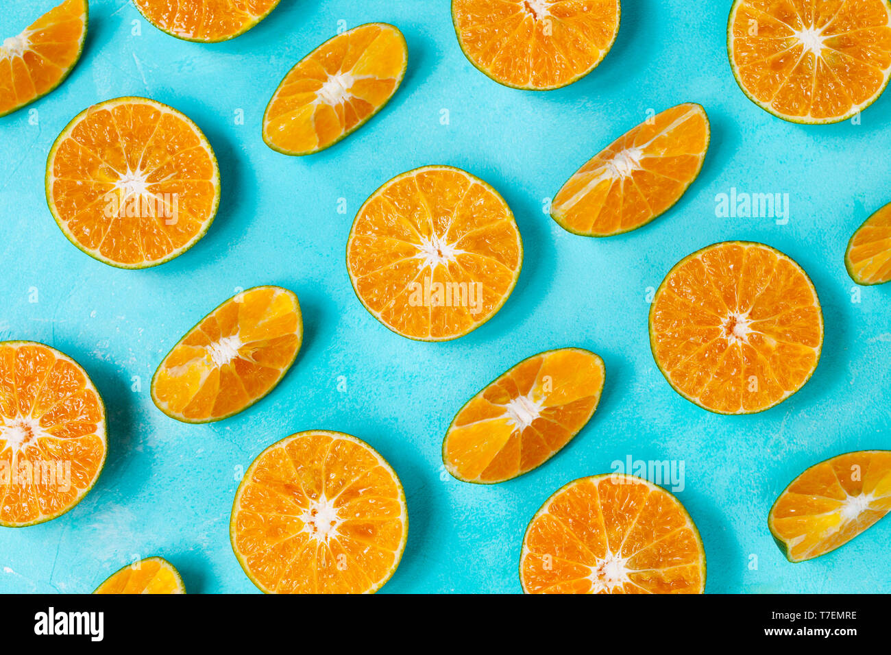Oranges on blue background. Flat lay composition. Top view. Stock Photo