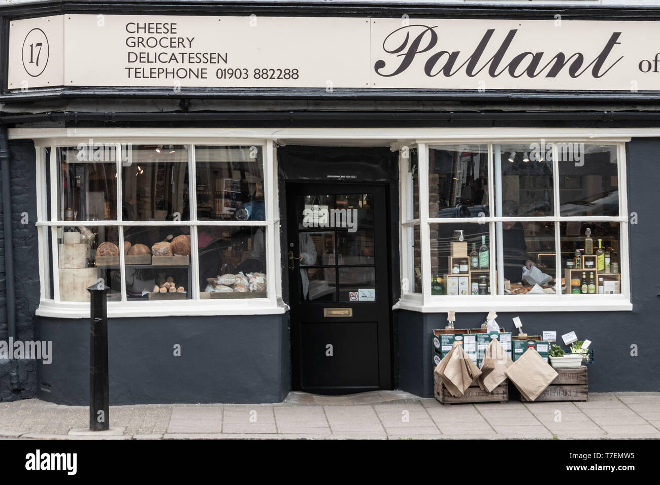 The front of a typical old English bakers, delicatessen and grocery shop with an old style shop front Stock Photo