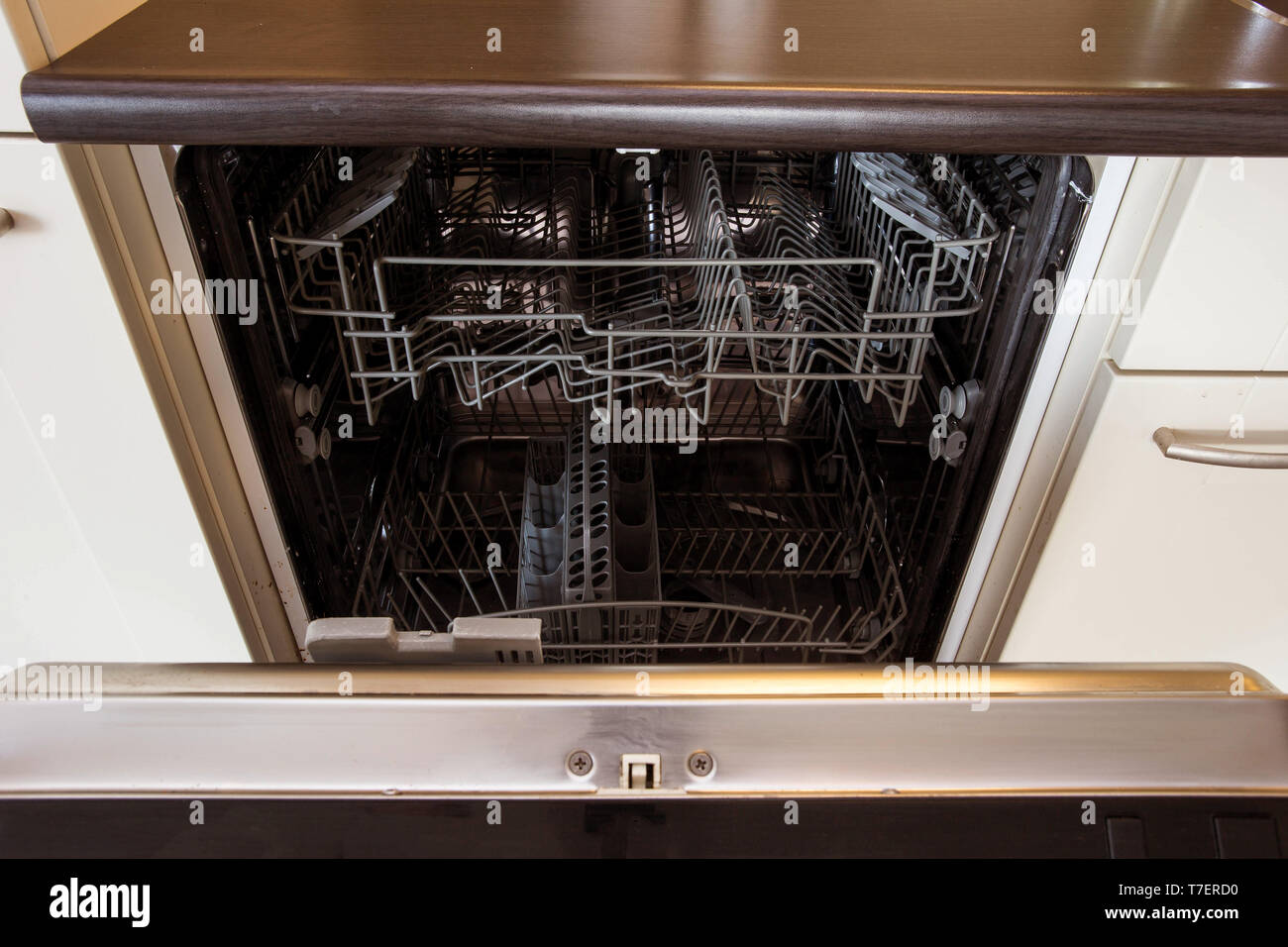 modern Half open empty dishwasher in a modern kitchen close-up Stock Photo