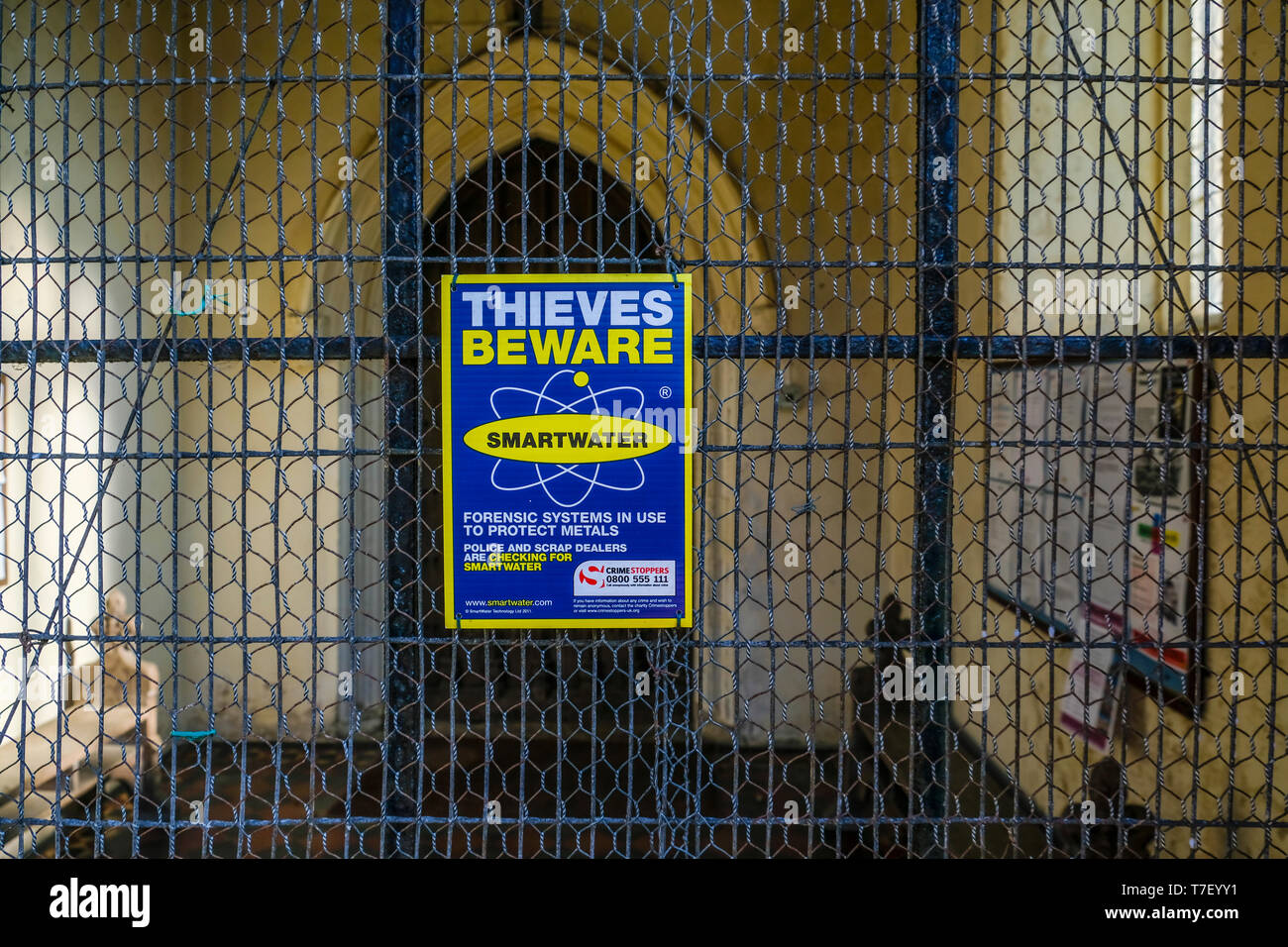 Thieves beware sign in a church porch. Stock Photo