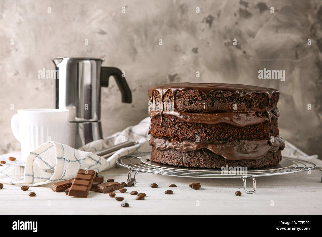 Cooling rack with delicious chocolate cake on table Stock Photo - Alamy