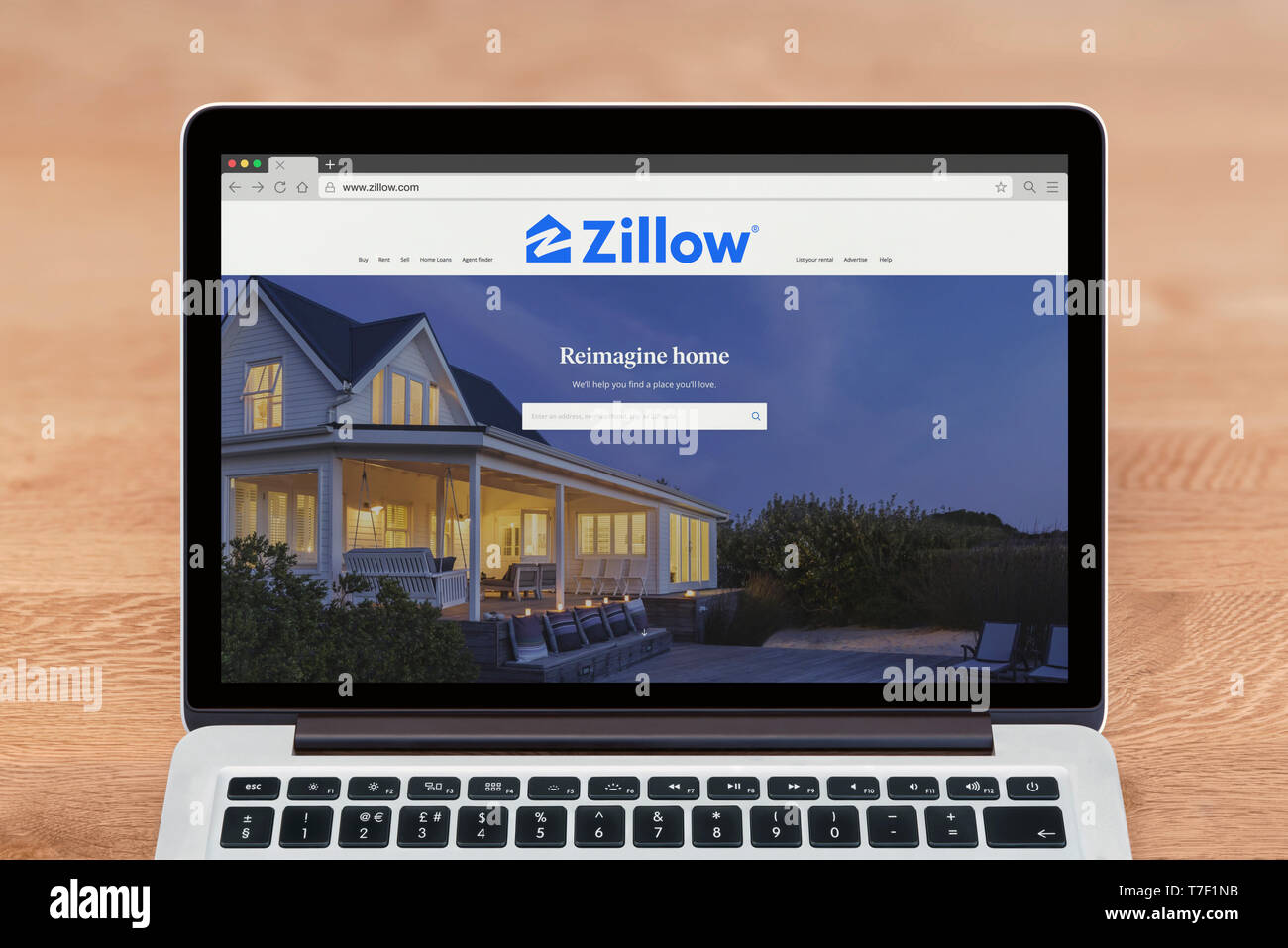 An Apple Macbook displays the Zillow website (Editorial use only). Stock Photo