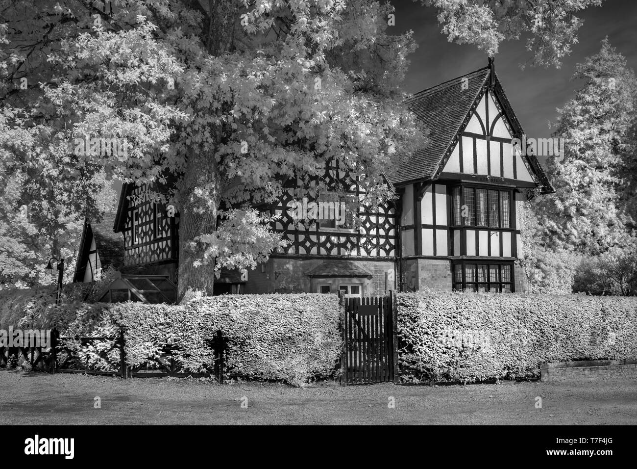 An Infrared image of the Lodge, Larmer Tree Gardens,Tollard Royal, Wiltshire UK. A historic timber framed victorian building. Stock Photo