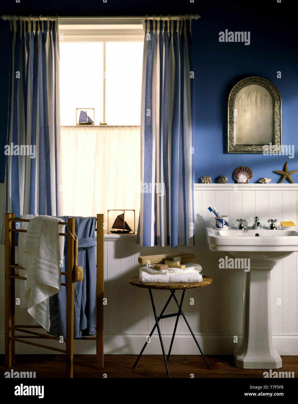 Blue Striped Drapes On Window In Blue Bathroom With Pedestal Basin