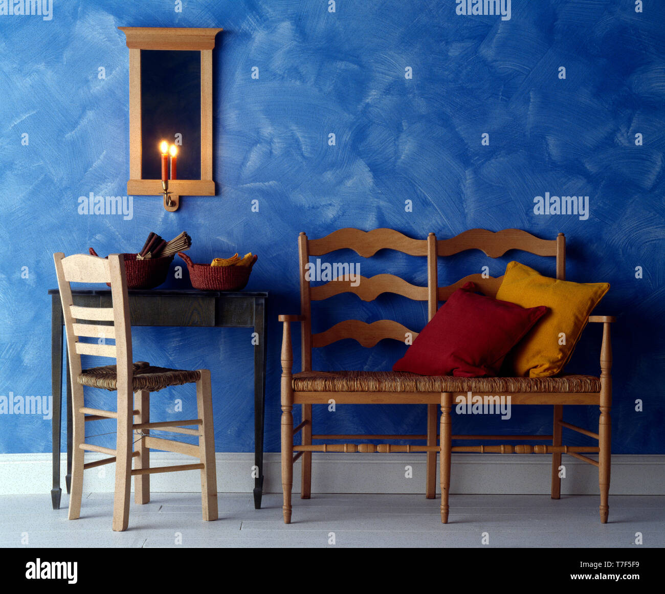 Settle and chair in blue room with ragging paint effect on wall Stock ...