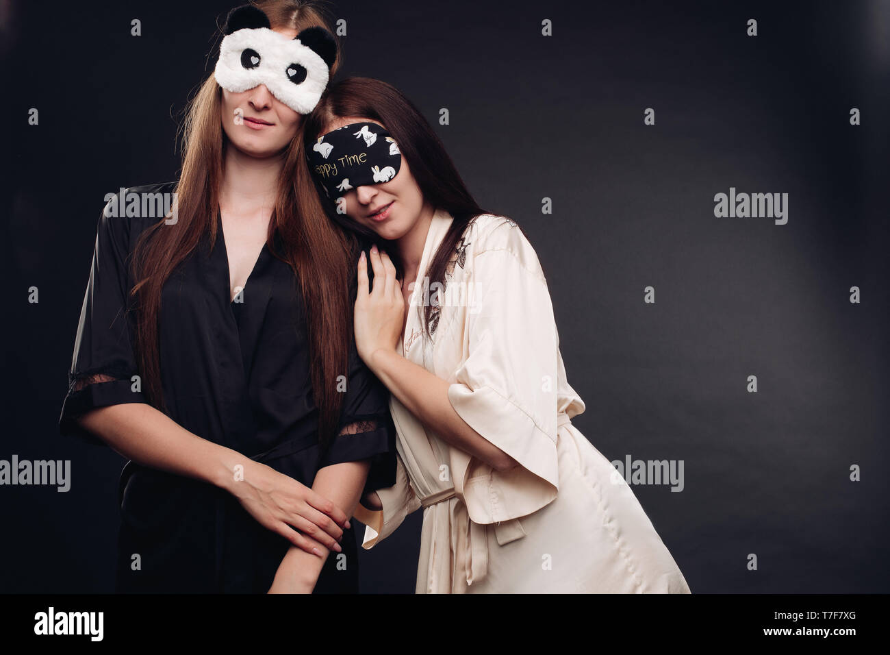 Two young tired girls wearing pajamas sleeping Stock Photo - Alamy