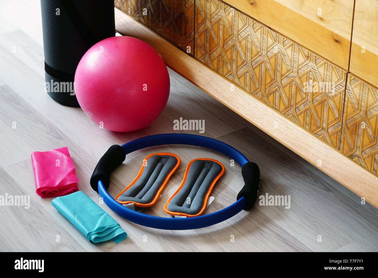 Pilates set with mat stretch ball on wooden background Stock Photo