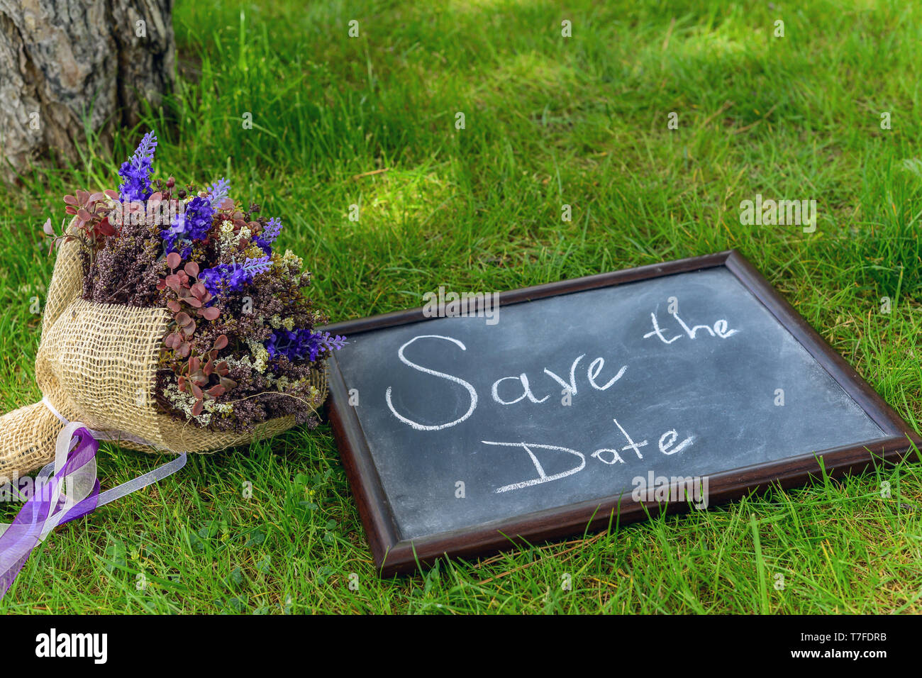 Chalkboard frame cleavage and bride bouquet save the date organisation Stock Photo