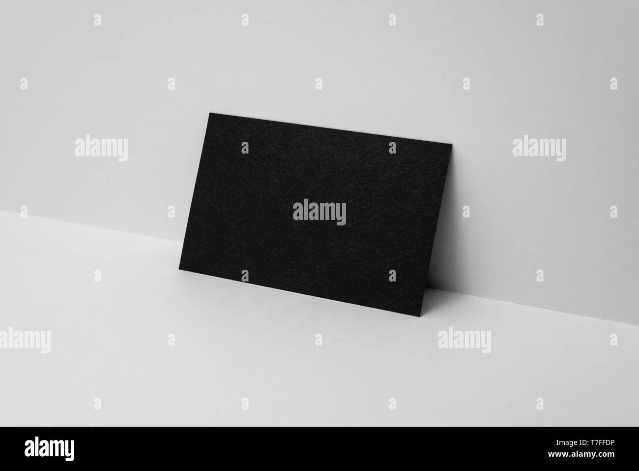 Design concept - perspective view of horizontal black business card on white 3D space background for mockup, it's real photo, not 3D render Stock Photo