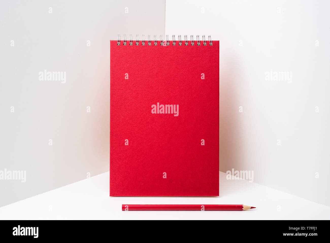 Design concept - perspective view of red spiral notebook, white page on white 3D space background for mockup, it's real photo, not 3D render Stock Photo