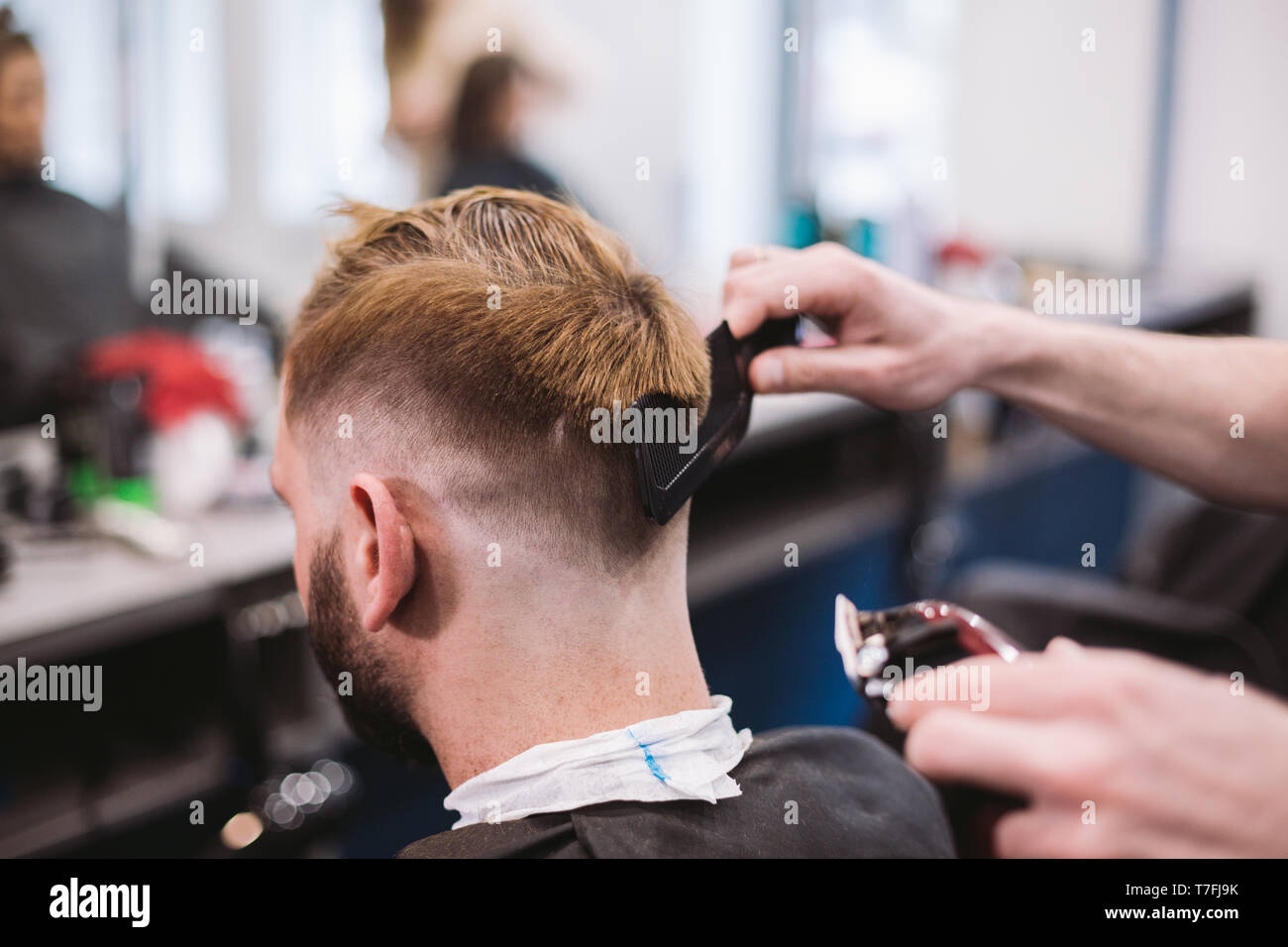 Close Up Shot Of A Man Getting A Trendy Haircut At A Hair Salon