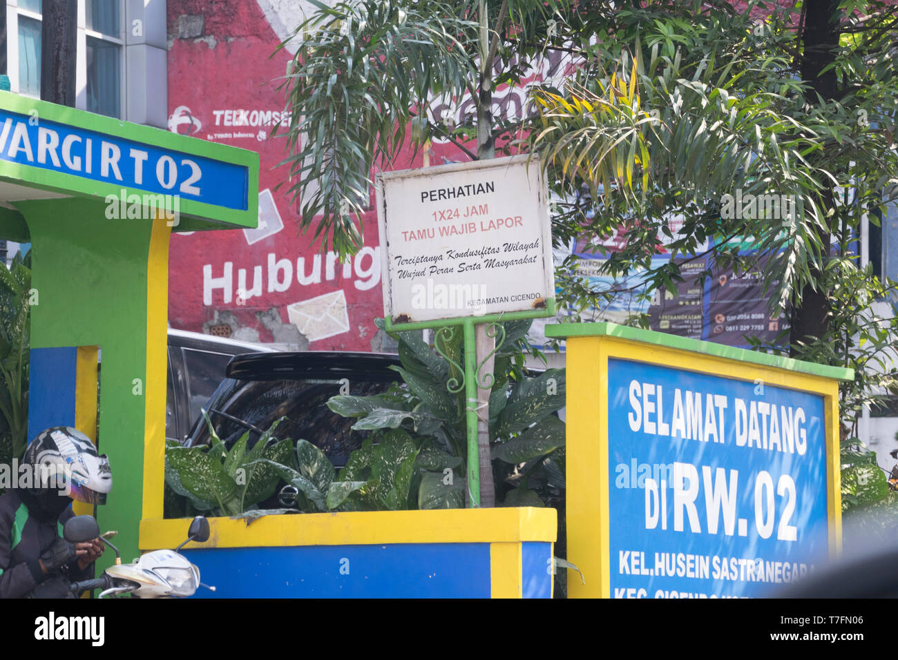 A typical alley of residential housing with the name, welcome sign and 'tamu harap lapor' notification (more than 1x24 hours guest please report) Stock Photo