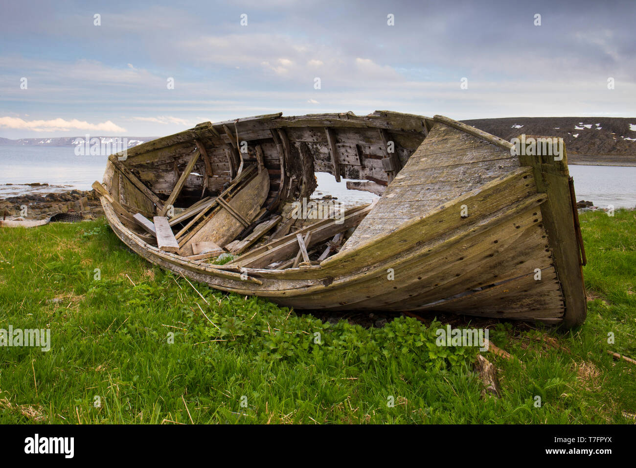 Old boat, laying on the ground close to the sea Stock Photo