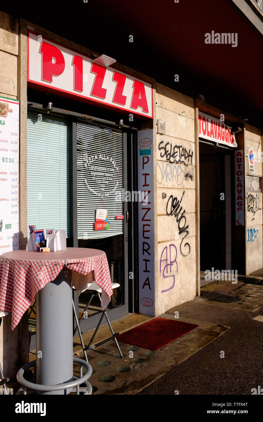 A traditional pizza restaurant with a table in the street, in Rome, Italy Stock Photo