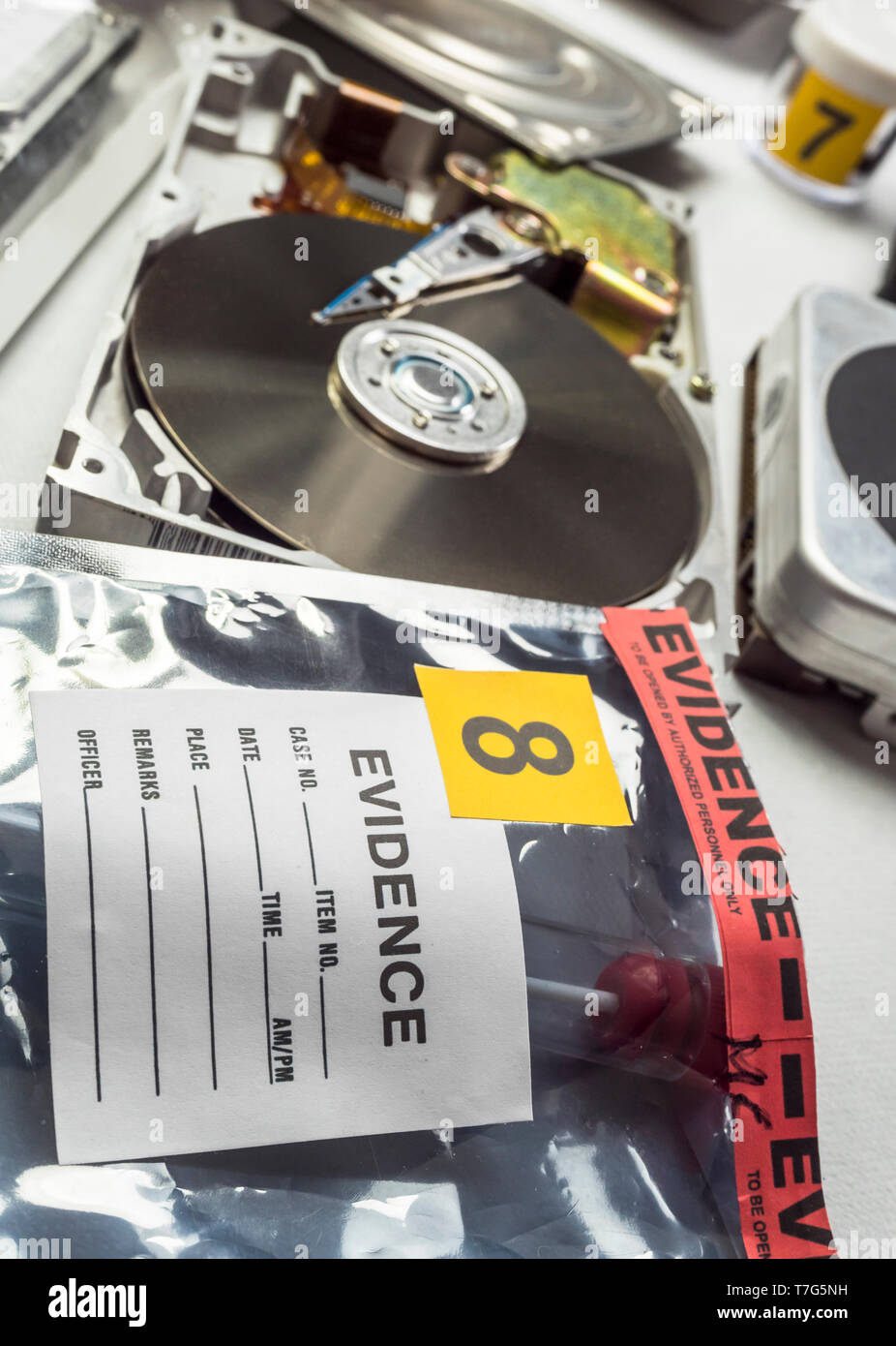 Police expert examines hard drive in search of evidence, conceptual image Stock Photo