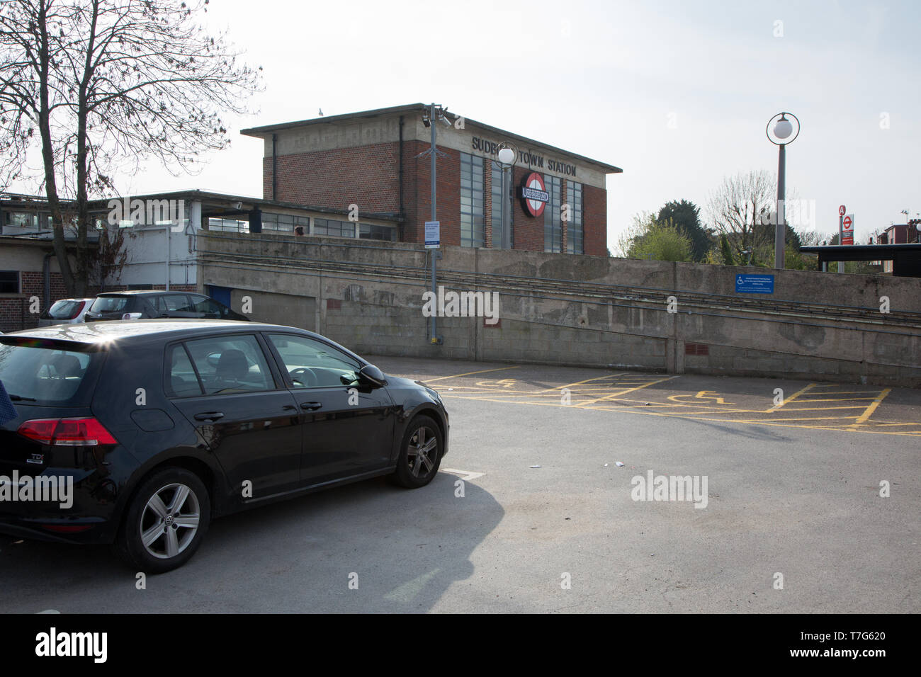 Ramp at Sudbury Town Station, which gives access for disabled people. Space for disabled parking is also visible on the carpark. Stock Photo