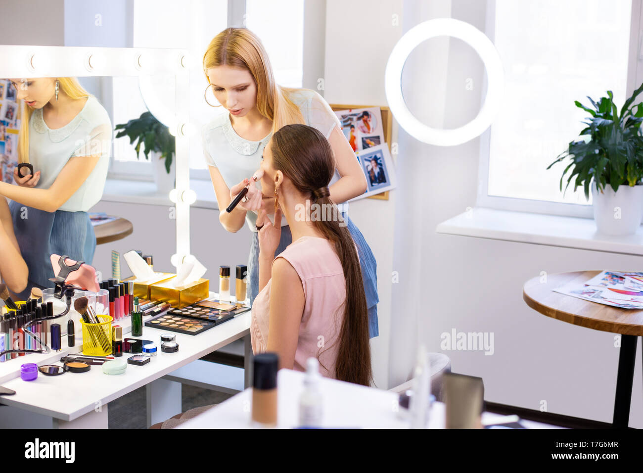 Blond woman putting on makeup hi-res stock photography and images - Alamy