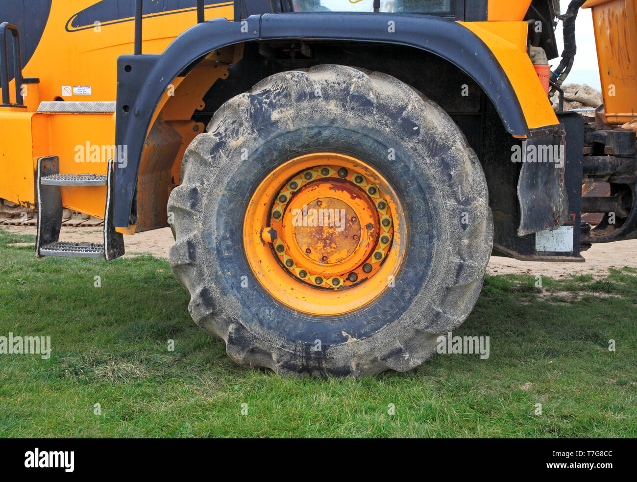 A large front wheel of a JCB articulated dump truck. Stock Photo