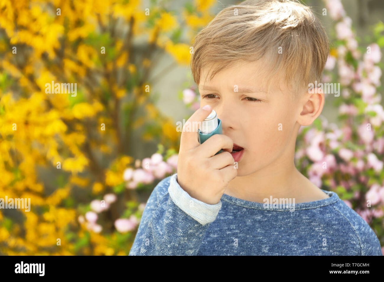 Little boy using inhaler near blooming tree. Allergy concept Stock ...