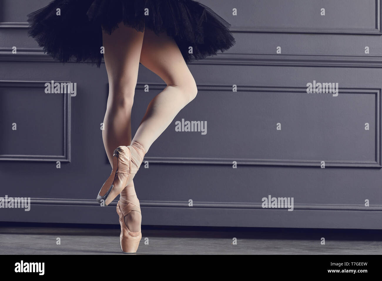 Legs of a ballerina on a black background. Stock Photo