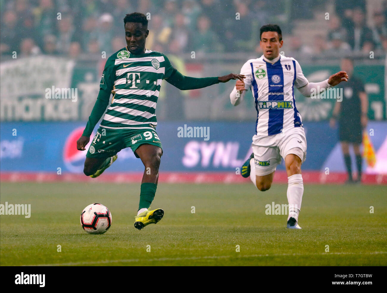 BUDAPEST, HUNGARY - MAY 4: Ihor Kharatin of Ferencvarosi TC #14 blocks the  shot from Vincent Onovo of Ujpest FC (l) before Tokmac Chol Nguen of Ferencvarosi  TC #92 during the Hungarian