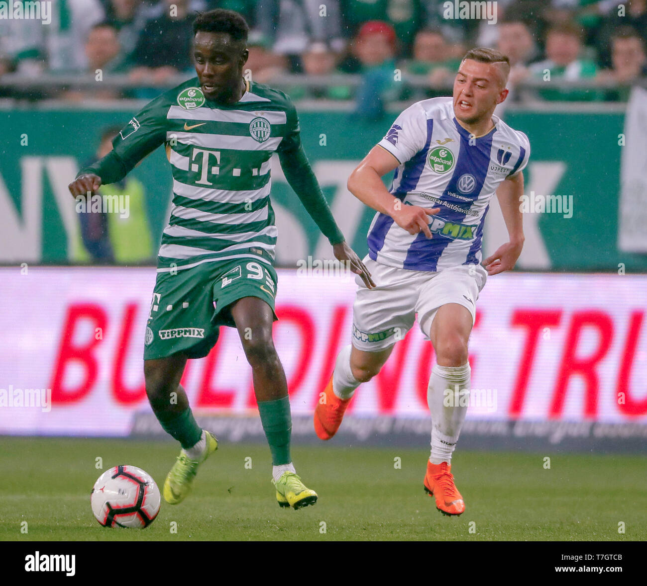 BUDAPEST, HUNGARY - MAY 4: Ihor Kharatin of Ferencvarosi TC #14 blocks the  shot from Vincent Onovo of Ujpest FC (l) before Tokmac Chol Nguen of Ferencvarosi  TC #92 during the Hungarian