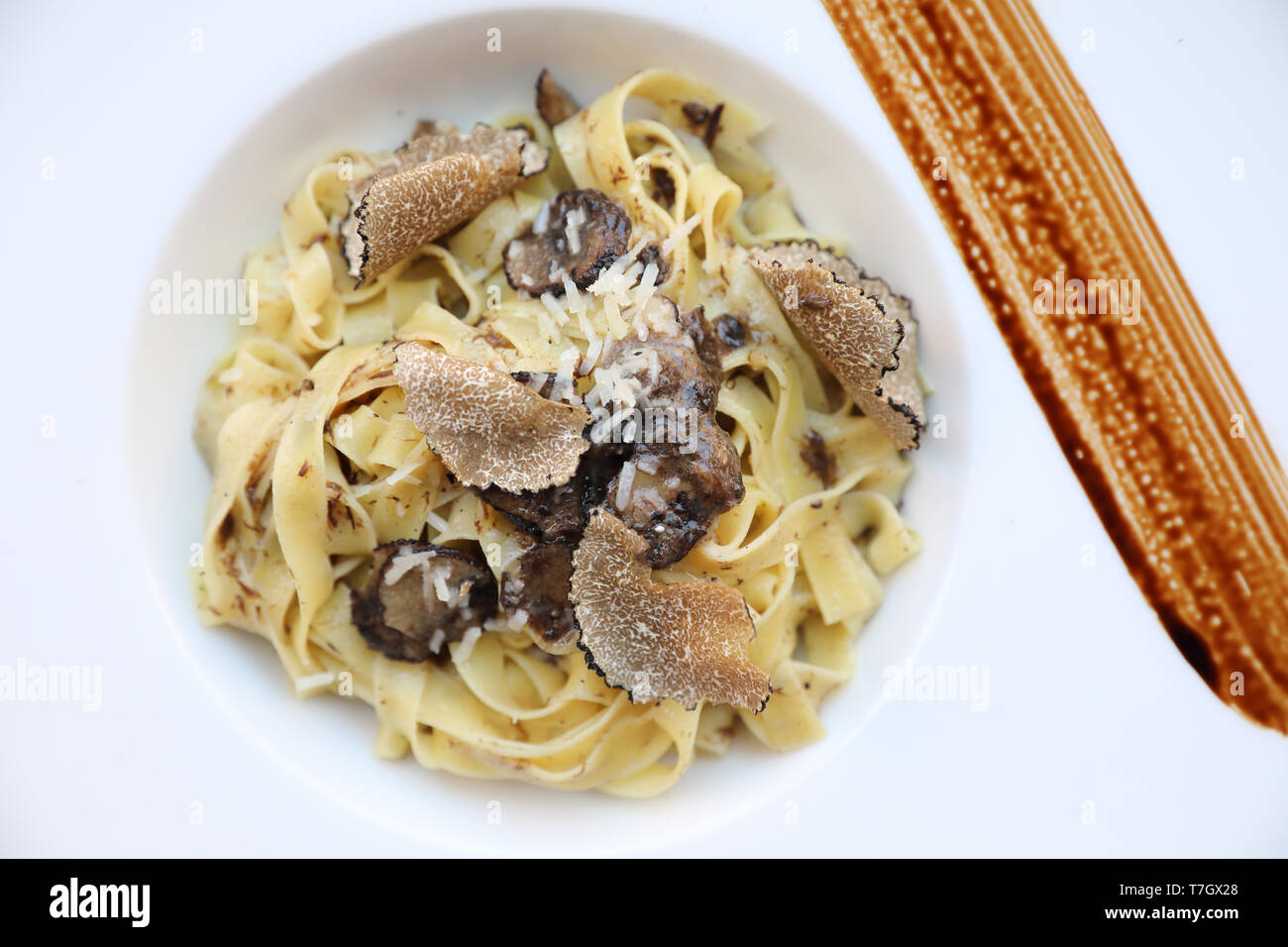 pasta with black truffles on wood background , Italian food Stock Photo