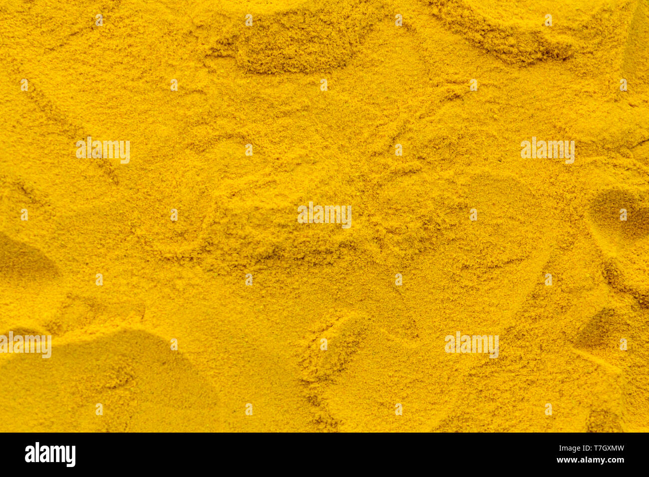 Turmeric powder texture background pattern Stock Photo - Alamy