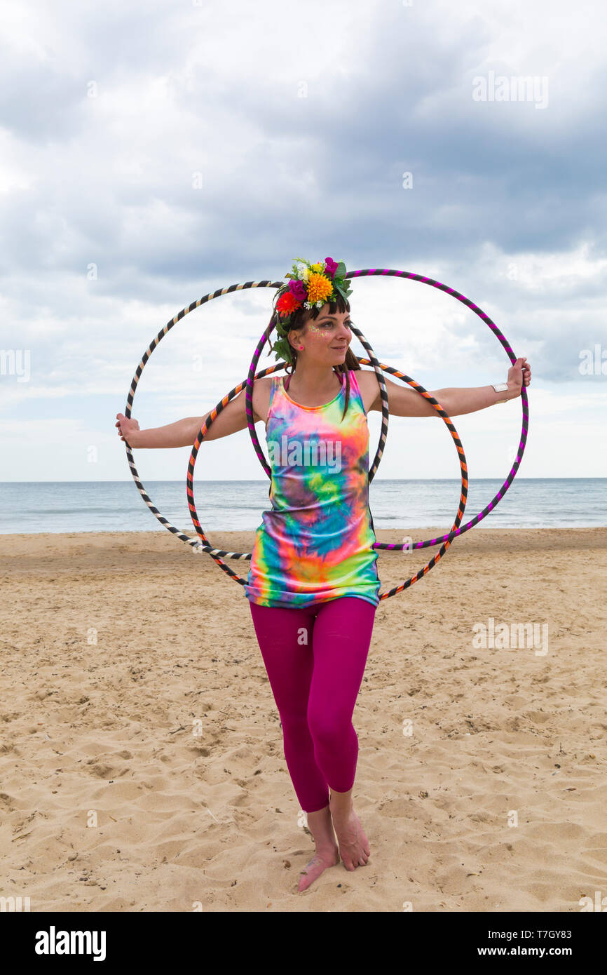 Lottie Lucid with her hula hoops on Boscombe Beach, Bournemouth, Dorset UK in May Stock Photo