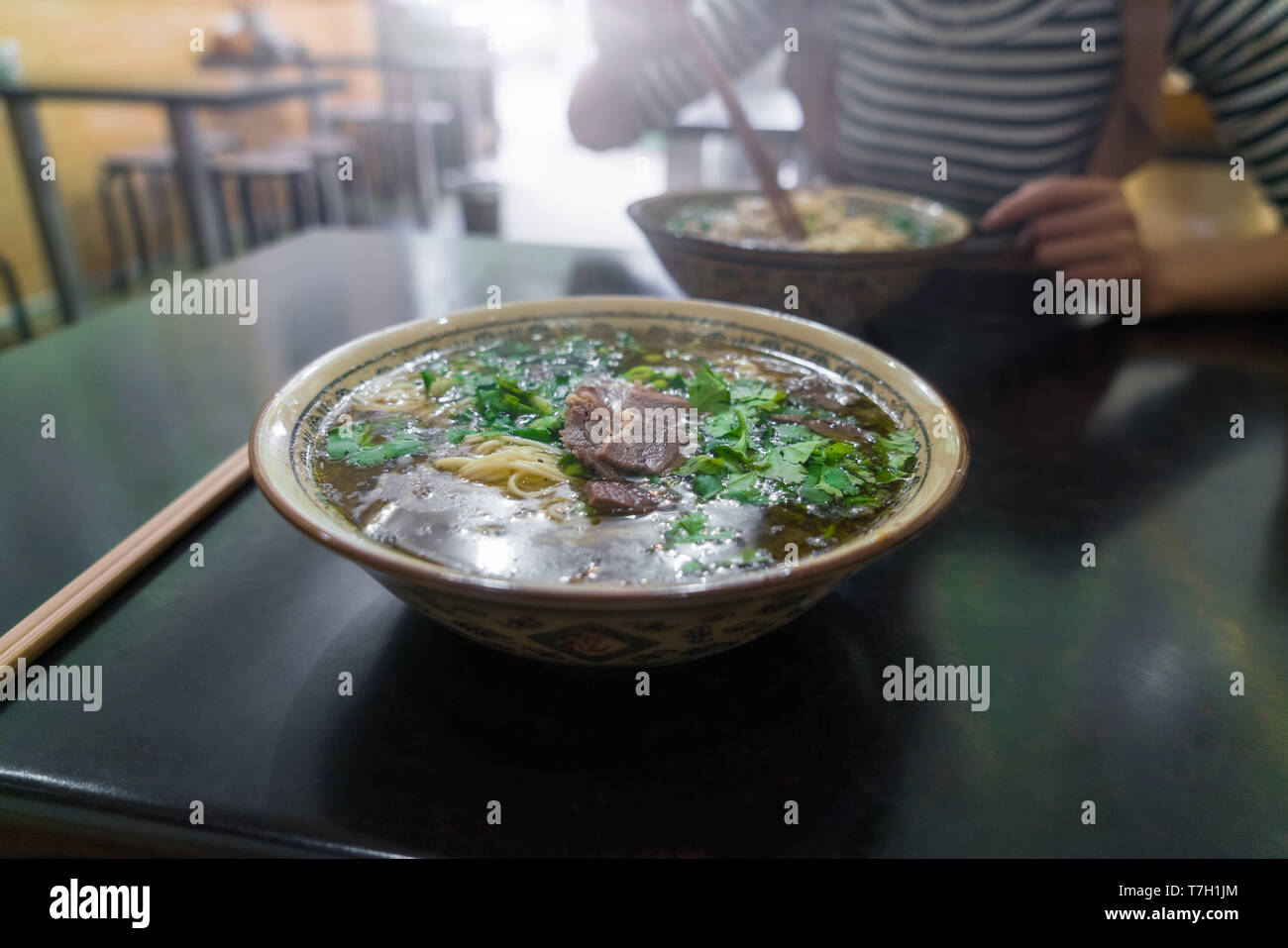 Bowl of real chinese noodles in real chinese restaurant in China Stock Photo