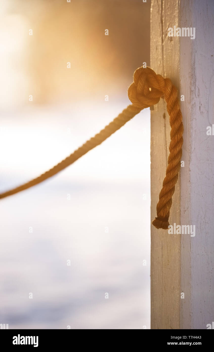 Rope knotted in to the pole. Focus on knot. Stock Photo