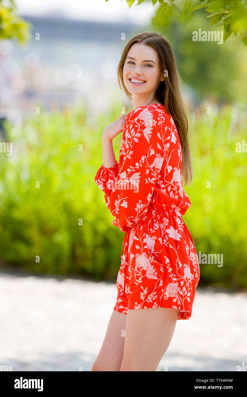 Beautiful young woman in red jumpsuit Stock Photo