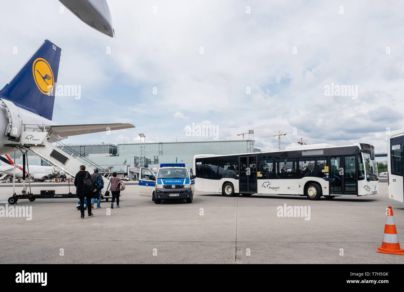 Frankfurt, Germany - Apr 29, 2019: Airbus A321-231 D-AISO on tarmac with Polizei police van and Fraport bus with passengers preparing for departure wide image Stock Photo