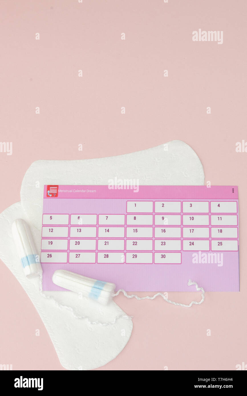 Tampon, feminine, sanitary pads for critical days, feminine calendar, pain  pills during menstruation on a pink background. Tracking the menstrual cycl  Stock Photo - Alamy