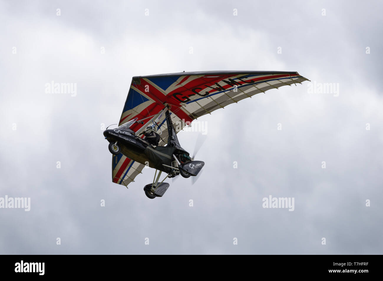 Patriotic Union Jack design on the wing of this Quik GT450 flex wing microlight as it flies abovce Popham Airfield in Hampshire Stock Photo