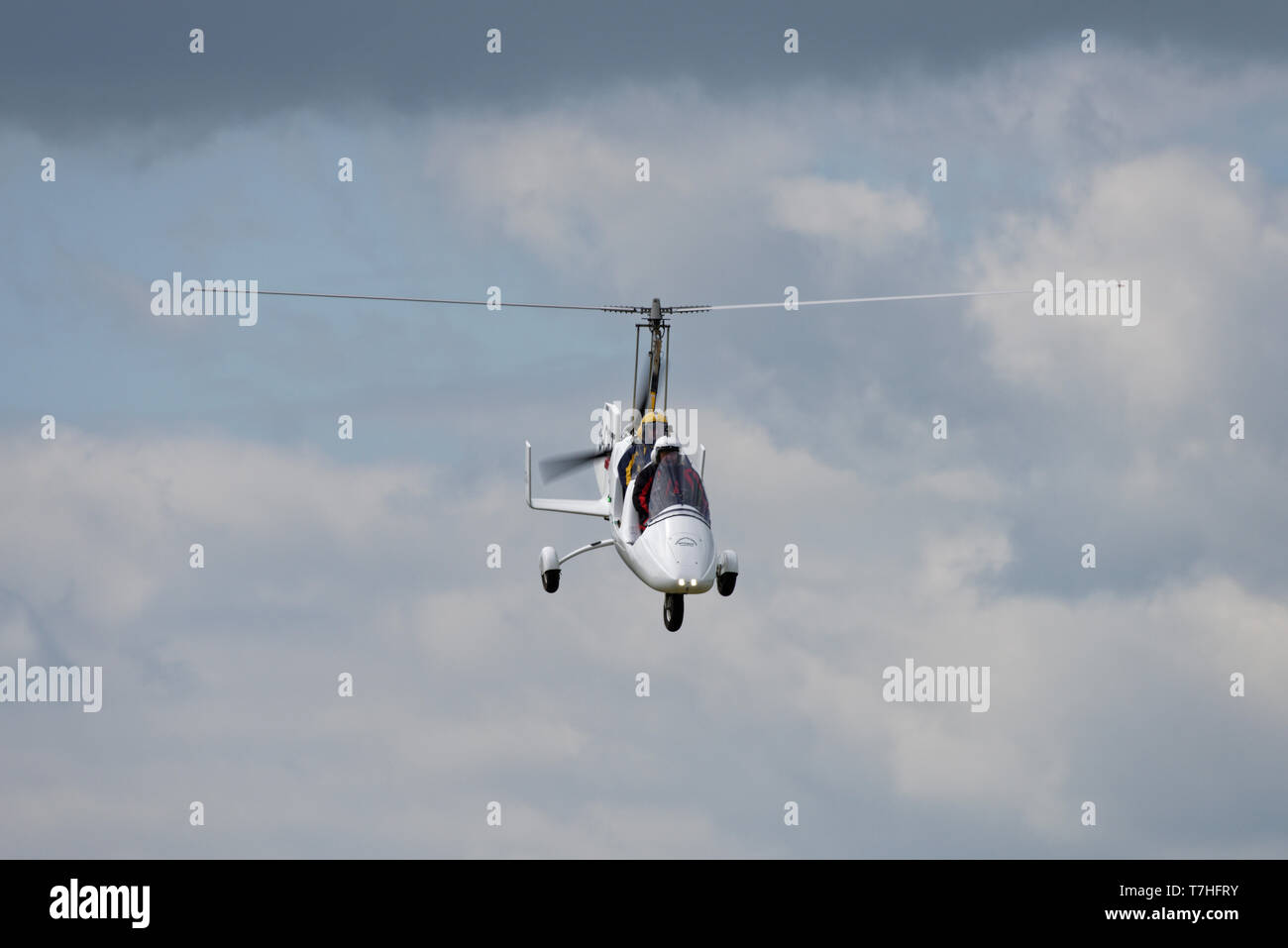 A Rotorsport gyrocopter G-CIRT descends for a landing at Popham Airfield in Hampshire at the Spring Fly-in event. Stock Photo