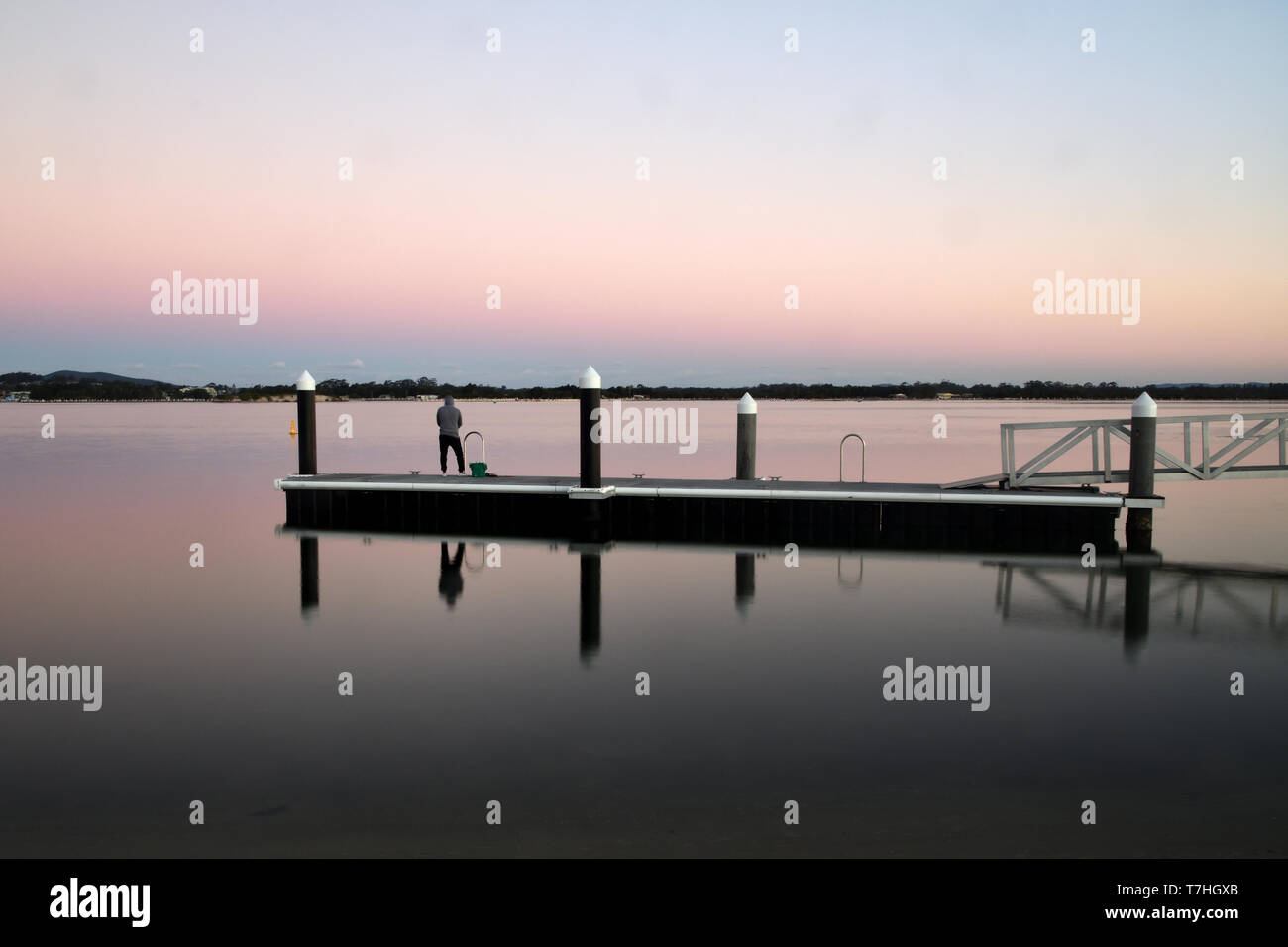 a man fish on the long jetty Stock Photo