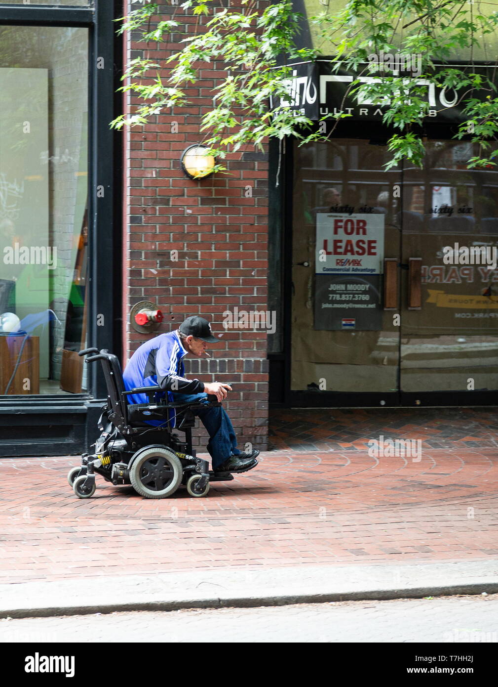 Smoking Man in Wheelchair Stock Photo